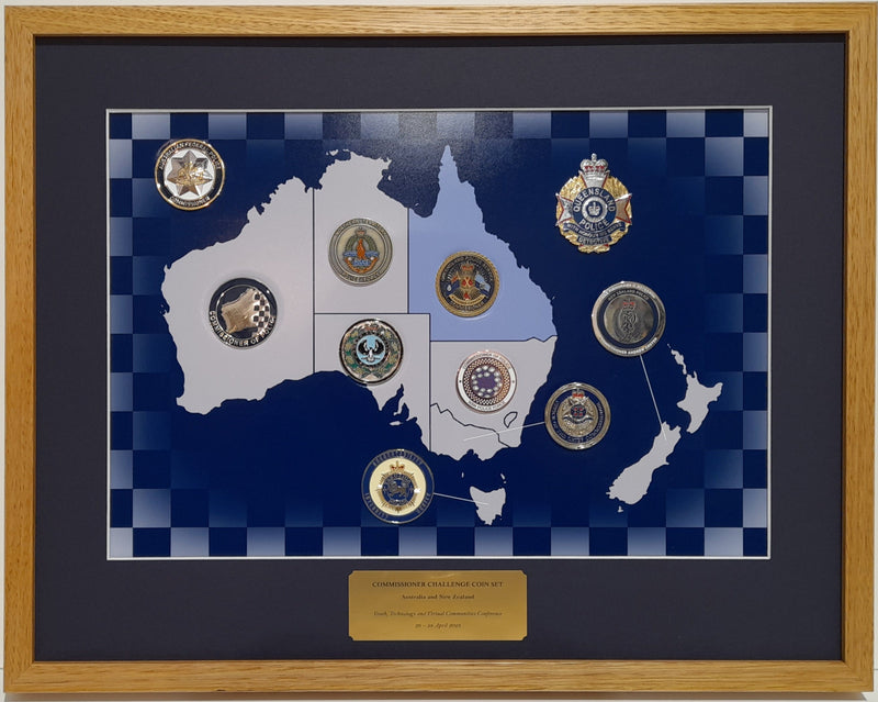 Framed display of Australian Police Commissioner coins on a map background